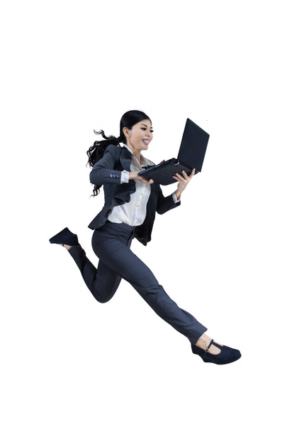 Excited woman running and holding laptop - Photo, image