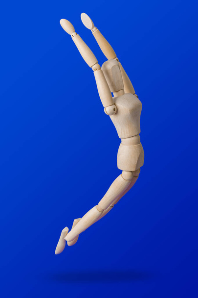 Sports wooden toy figure on blue - Фото, зображення