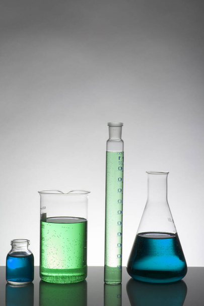 Liquid in laboratory bottles. Scientific biochemical laboratory. Colorful liquid. - Фото, изображение