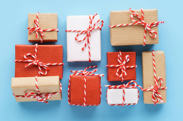 Collection of handcrafted gift boxes on light blue background. - Zdjęcie, obraz