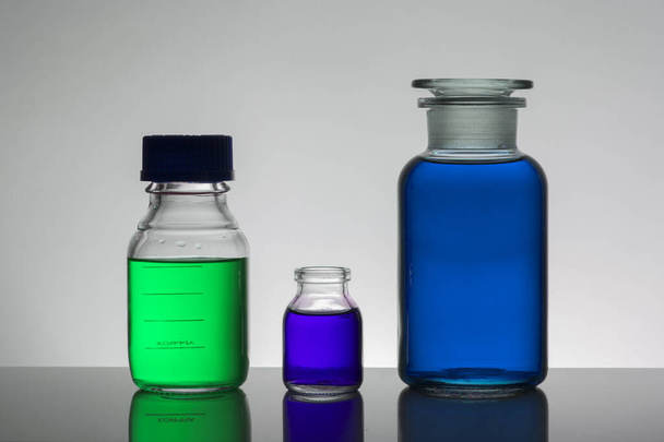 Liquid in laboratory bottles. Scientific biochemical laboratory. Colorful liquid. - Photo, Image