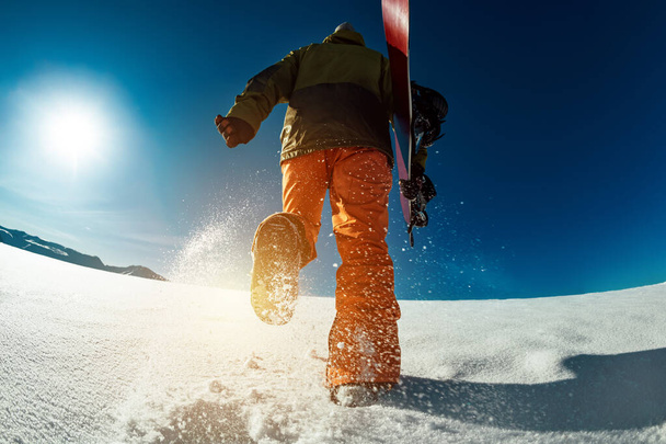 Snowboarder goes uphill backcountry skiing - Photo, Image
