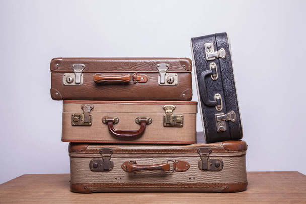 Old, retro, suitcases lie on the table with white background - Zdjęcie, obraz