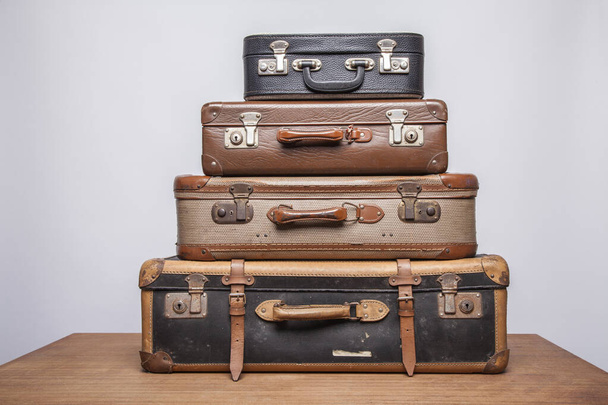 Old, retro, suitcases lie on the table with white background - Foto, Imagem