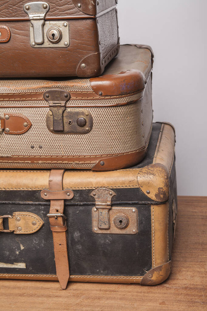 Old, retro, suitcases lie on the table with white background - 写真・画像