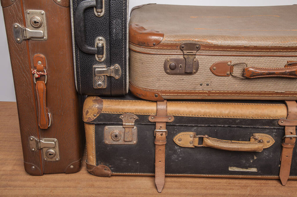 Old, retro, suitcases lie on the table with white background - 写真・画像