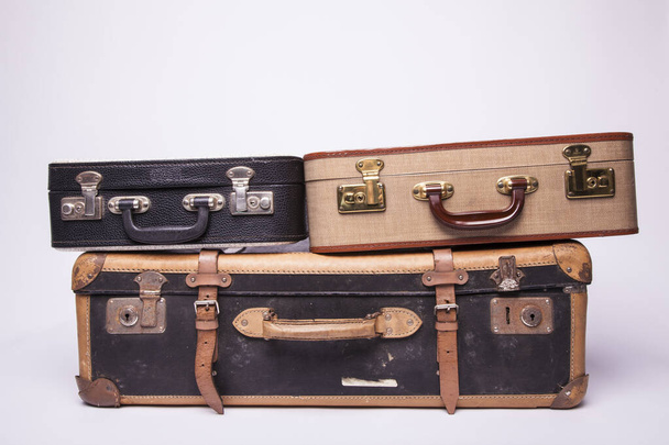 Old, retro, suitcases lie on the table with white background - Foto, Bild