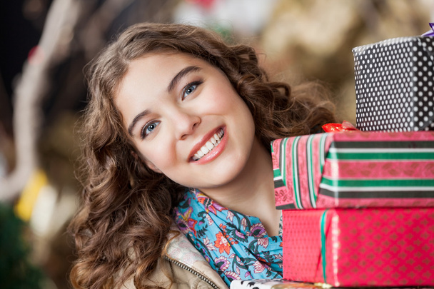 Attractive Woman With Christmas Presents In Store - Fotografie, Obrázek