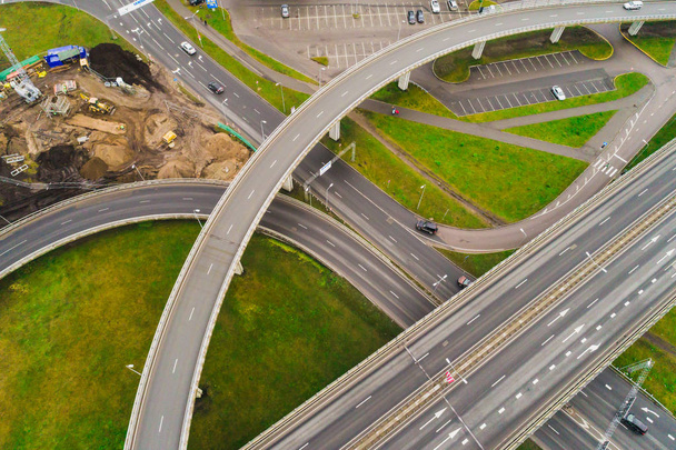 Aerial view at junctions of city highway. Vehicles drive on road - Photo, Image