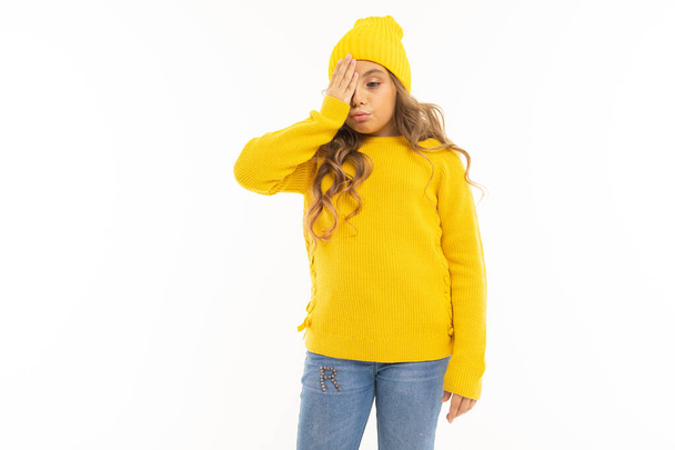 beautiful girl in yellow clothes posing against white background - Zdjęcie, obraz