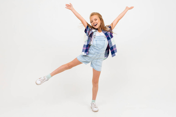 cute emotional little girl posing in studio against gray background - Photo, Image
