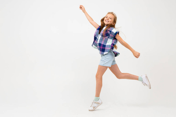 cute emotional little girl posing in studio against gray background - Photo, Image
