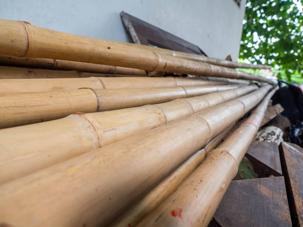Long bamboo is pile up mountain high,Used as a building material,Is a natural material - Photo, Image