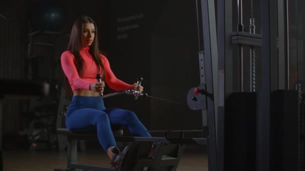 Workout woman cross training exercising cardio using rowing machine in fitness gym - Footage, Video