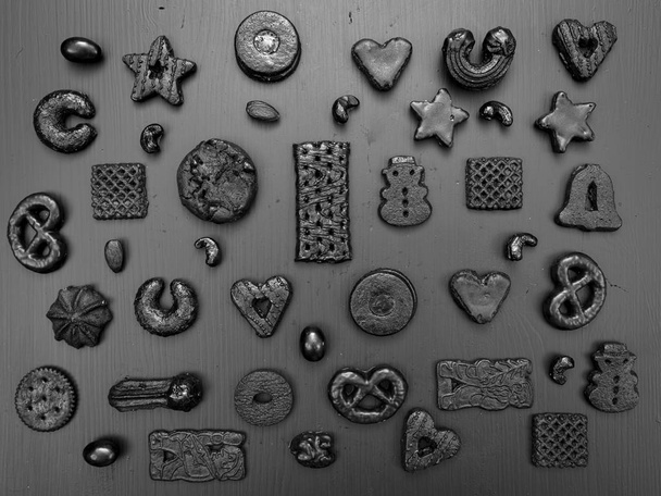 collection of black christmas cookies on grey wooden background - Φωτογραφία, εικόνα