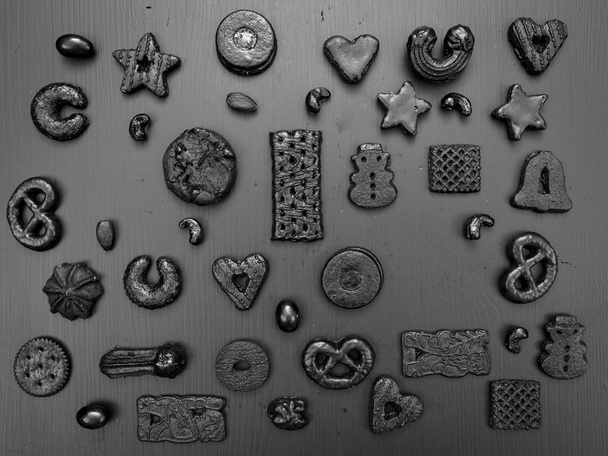 collection of black christmas cookies on grey wooden background - Fotografie, Obrázek