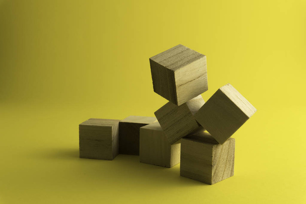 wooden blocks on a yellow background. - Фото, зображення