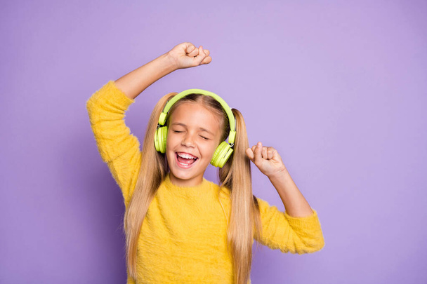 Portrait of funky crazy kid with ponytails listen music have break pause use headset sing song dance on party wear trendy jumper isolated over violet color background - Φωτογραφία, εικόνα