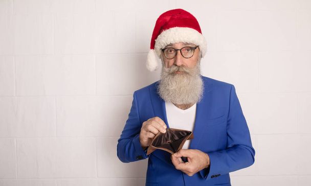 Santa Claus holding purse with out money on white background. No money fo Xmas. New year. - Фото, зображення