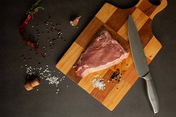 Steak raw. Barbecue Rib Eye Steak or rump steak on rustic table with rosemary. T-Bone steak. - Photo, Image