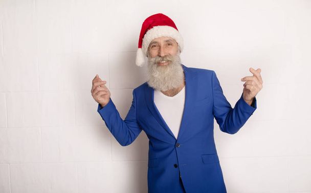 Holly jolly xmas, new year is soon! Be ready, prepare. Sales, discounts, presents, gifts selling time. Man wearing blue suit and red hat. - Foto, Imagem