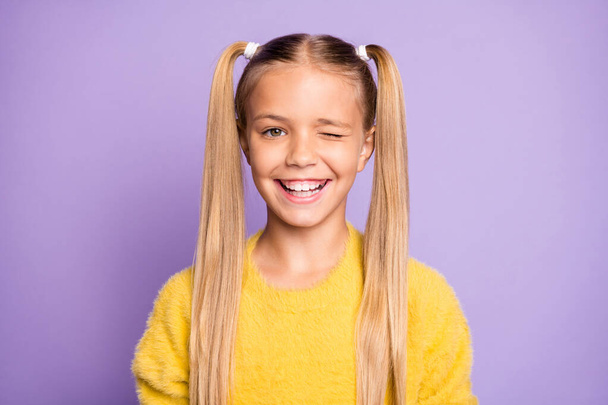 Photo of cute positive cheerful girl winking at you to draw your attention isolated over pastel violet color background - Fotografie, Obrázek