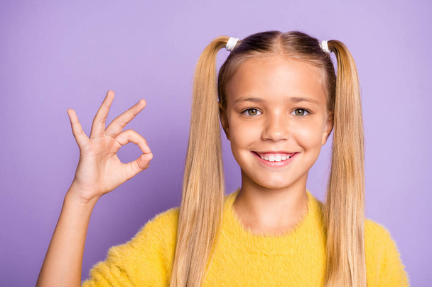 Close up photo of casual positive toothy beaming girl showing you ok sign expressing positive emotions on face isolated violet pastel color background - Foto, imagen