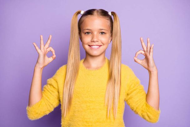 Portrait of positive cheerful cool kid future promoter show okay sign recommend ads pick tips sales wear yellow pullover isolated over violet color background - Zdjęcie, obraz