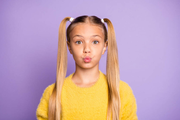 Portrait of confused funky kid made mistake have her lips pouted plump say oops feel frustrated anxious wear yellow sweater isolated over violet color background - Zdjęcie, obraz