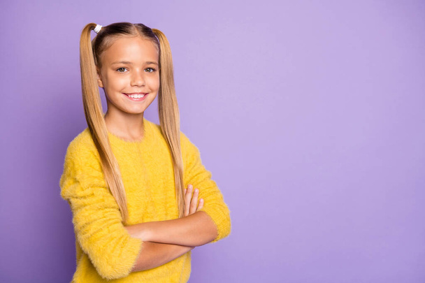 Turned photo of positive cool glad child future professional cross her hands good look wear yellow pullover isolated over purple color background - Zdjęcie, obraz