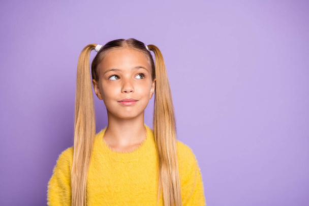 What decide. Portrait of minded positive cute child think thoughts plan her weekends look copyspace wear yellow sweater isolated over violet color background - 写真・画像