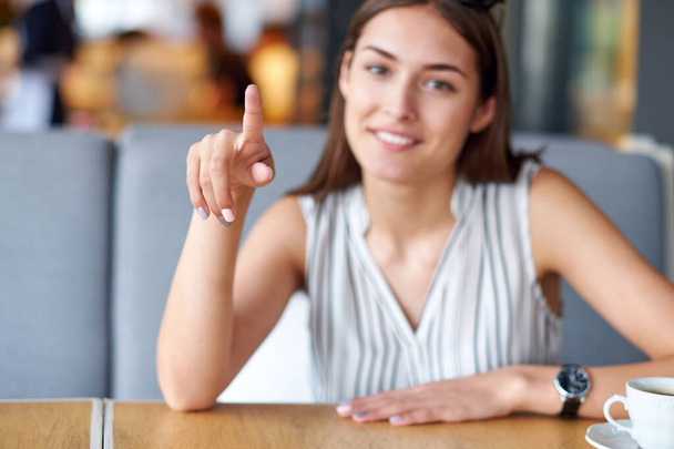 Writing finger in the air or push button. Woman holding floating render startup presentation. Place for note - Photo, image