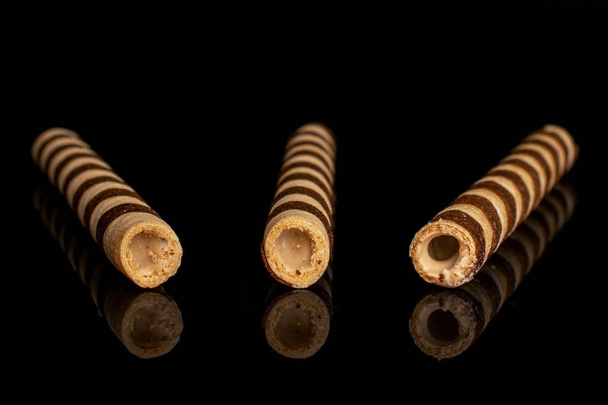 Hazelnut rolled wafer biscuit isolated on black glass - Zdjęcie, obraz