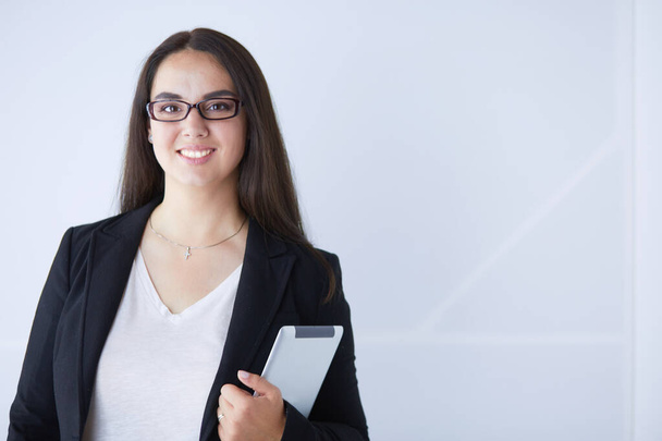 Portrait of smiling young business woman with digital tablet in her hands. - Photo, image