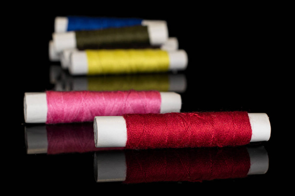 Sewing thread spool isolated on black glass - 写真・画像