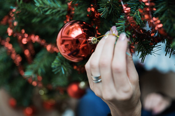 Hanging red bauble on Christmas tree - Φωτογραφία, εικόνα