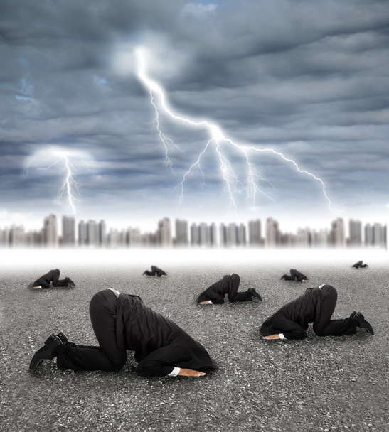 scared businessman hiding on the ground with storm coming - Photo, Image