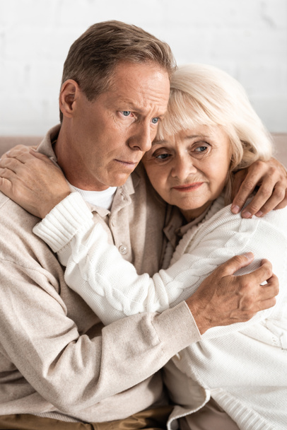 frustrated retired woman hugging senior husband with mental illness  - Fotoğraf, Görsel