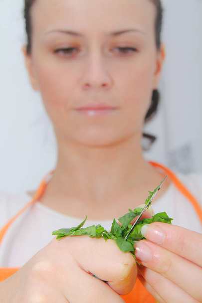 Woman preparing healthy meal, spinach in her modern kitchen - Photo, Image