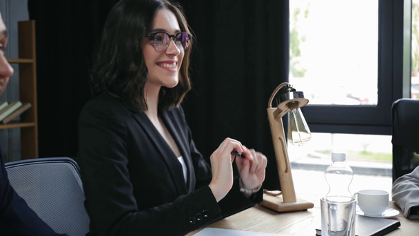 alegre mujer de negocios hablando, y colega frotándose las manos en la reunión de negocios
 - Metraje, vídeo