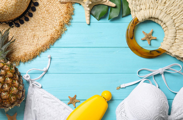 Flat lay composition with beach objects on light blue wooden background. Space for text - Fotoğraf, Görsel