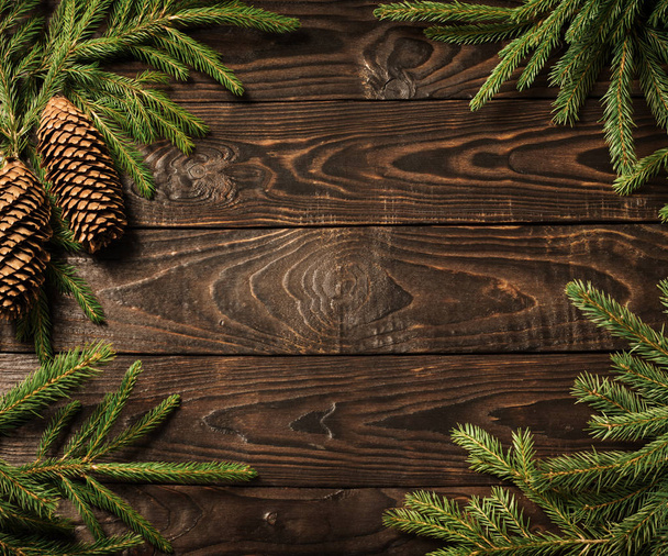 fir branches and cone on dark old wooden background  - Foto, imagen