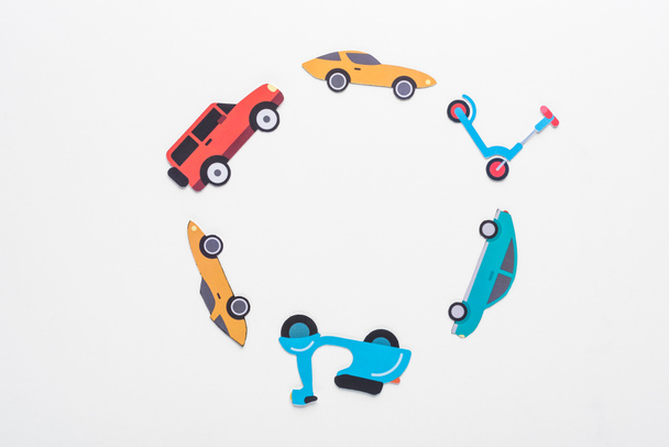 top view of paper cut vehicles arranged in round frame on white background with copy space - Photo, Image