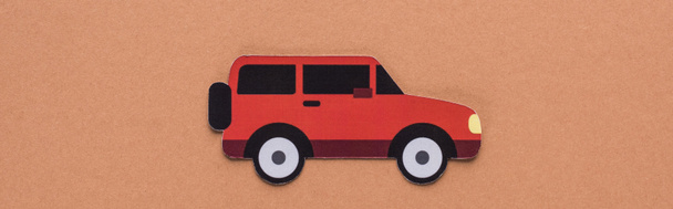 top view of paper cut car on brown background, car rent concept - Foto, Bild