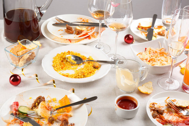 Food leftovers after party on table with cloth - 写真・画像