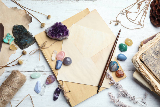 Flat lay composition with different gemstones on white wooden background - Fotó, kép