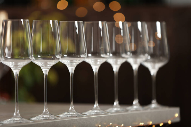 Set of empty wine glasses on grey table against blurred background - Фото, зображення