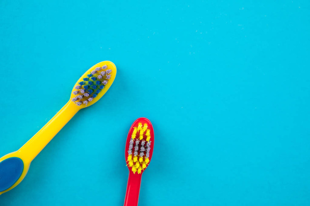 Teeth brushing concept. Toothbrushes on blue background top view - Photo, Image