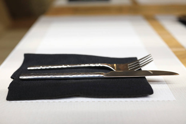 Fork with knife on napkin - Foto, afbeelding