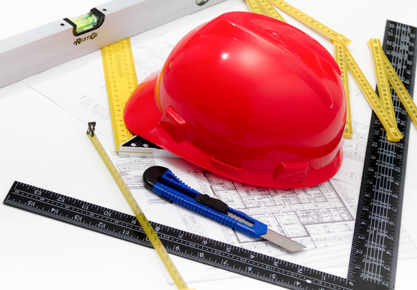 Helmet and tools for construction drawings and buildings - Foto, Imagen